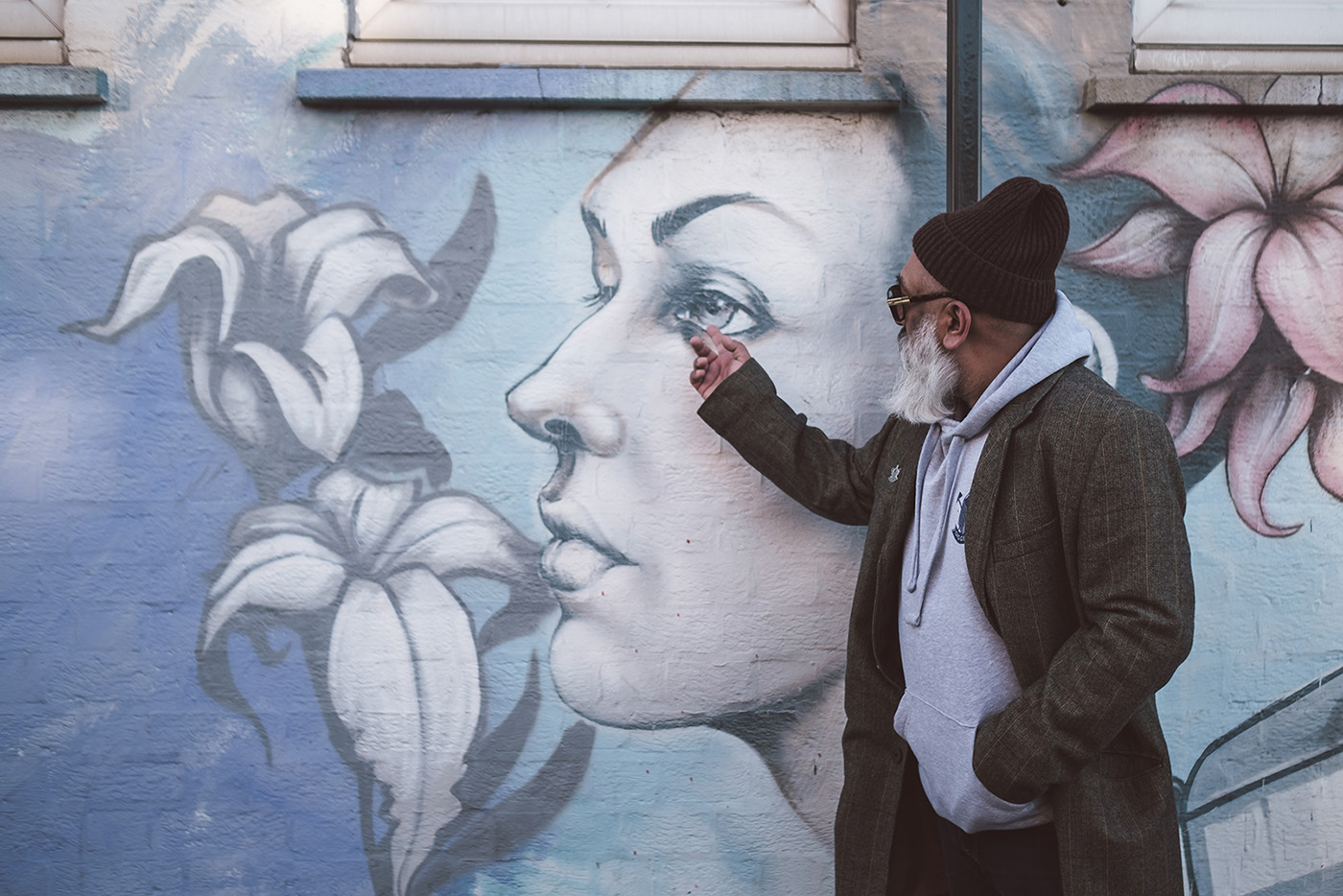 Man next to street art mural