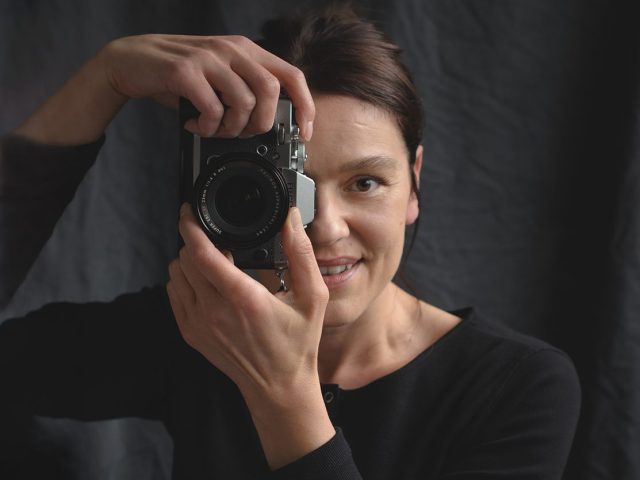 Portrait of photographer holding camera
