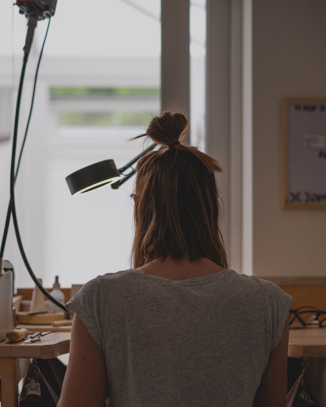 Silversmith working at the jewellery making bench
